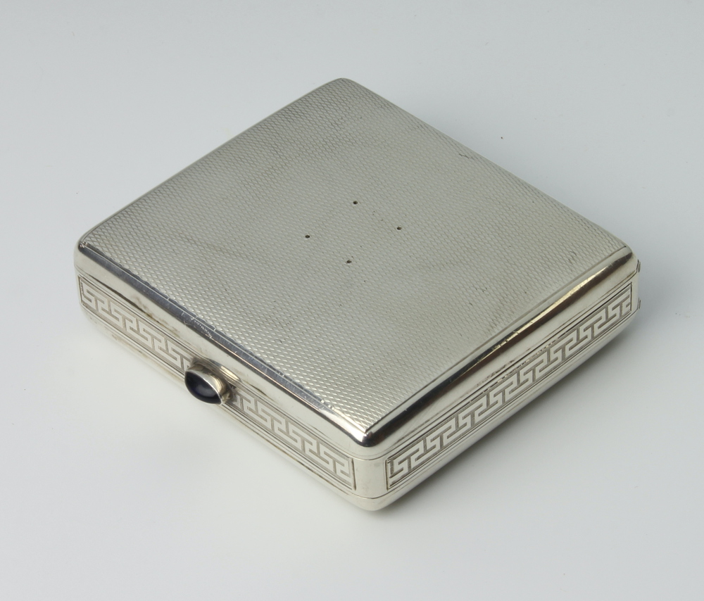 A 925 standard silver folding triple cigarette case with Greek key pattern border and gem stone