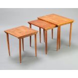 A mid-Century nest of 3 teak interfitting coffee tables, raised on turned supports 49cm h x 54cm w x