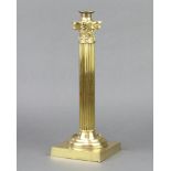 A Victorian brass oil lamp base in the form of a reeded column with Corinthian capital raised on