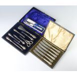 An Edwardian cased silver accessories set (8), together with a cased set of tea knives and a