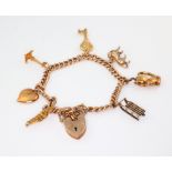 A 9ct yellow gold charm bracelet and heart shaped padlock 29 grams gross