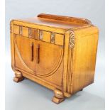 A 1930's Art Deco carved oak and ply sideboard with raised back, fitted a shelf and 2 drawers