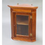 A Georgian style mahogany hanging corner cabinet, interior fitted a shelf with moulded cornice and