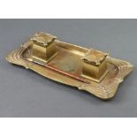 An Art Nouveau gilt metal twin bottle ink stand incorporating a tray, raised on bun feet, base