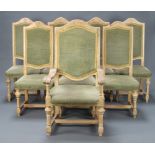 A set of 8 limed oak high backed dining chairs with upholstered seats and backs, raised on turned