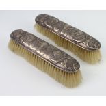 Two silver mounted Reynolds angels clothes brushes, rubbed marks