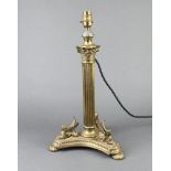 A Victorian reeded gilt metal oil lamp base with Corinthian capital triform base supported by sphynx