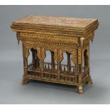 A Moorish inlaid games table with arched and bobbin turned decoration to the apron, the interior