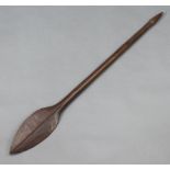 A carved Eastern hardwood paddle with leaf shaped head 113cm l x 13cm w Some chips to the edge and