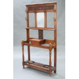 An Edwardian Art Nouveau carved oak hall stand with carved cornice fitted 6 hooks, having a