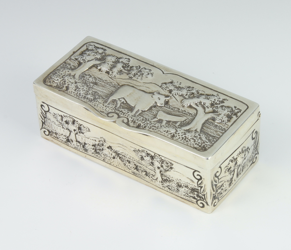A George III rectangular repousse silver trinket box decorated with a cow beneath trees, the sides