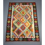 A white, green and turquoise ground Chobi kilim rug with overall diamond design 154cm x 103cm