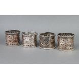 A set of 4 silver plated pierced repousse bottle holders 9cm