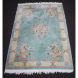 A green and cream ground Chinese rug with dragon medallion to the centre 282cm x 185cm Some staining