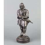 A bronzed figure of a standing cavalier raised on a circular base marked Elton CD 1990, 27cm h x