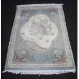 A blue and white ground Chinese rug decorated birds 280cm x 181cm Some moth and staining in places