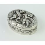 A 925 standard oval repousse pill box decorated with cherubs, 4.5cm, 38 grams