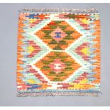 An orange, white and green ground Chobi Kilim with 2 diamonds to the centre 52cm x 51cm