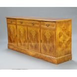 A Georgian style walnut oyster veneer and crossbanded sideboard, fitted a drawer above double