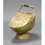 A Victorian Benham embossed brass coal scuttle, raised on a circular foot 50cm h x 30cm w x 51cm