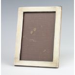 A rectangular silver photograph frame, Birmingham 1915, 16.5cm x 12cmThe frame has numerous dents