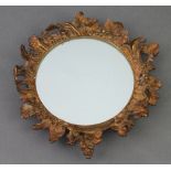 A 19th Century circular plate mirror contained in a gilt metal floral decorated frame 20cm