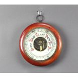 An aneroid barometer with porcelain dial contained in a mahogany case 5cm x 21cm