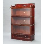 A mahogany Globe Wernicke 3 tier bookcase with raised three quarter gallery enclosed by glass