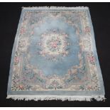 A blue and white floral patterned Chinese rug 247cm x 172cm Staining and moth damage