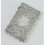 A silver cigarette case with engraved scrolling flowers and vacant cartouche Birmingham 1914, 54gms