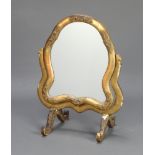 An Italian style shaped plate dressing table mirror contained in a decorative gilt frame 61cm x 47cm