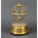 A Swiss Victorian style singing bird automaton contained in a gilt case, the base marked Reuge Music