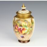 A Royal Worcester oviform vase decorated with fruits by Holroyd, having a reticulated lid 17cm