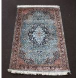 A North West Persian green and brown ground silk rug with central medallion 187cm x 122cm