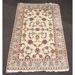 A North West Persian white ground part silk rug with floral decoration to the centre with a 4 row