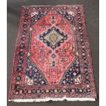 A blue and red ground North West Persian rug with central medallion within multi row border 207cm