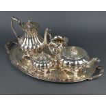 A silver plated 2 handled tray with engraved decoration and a 4 piece plated tea and coffee set