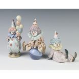 A Lladro figure of a seated boy clown 5912 12cm, ditto balloon seller 911 18cm and another sitting