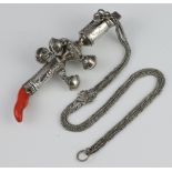 A 19th Century white metal rattle, teether and whistle with engraved decoration having a coral end