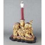 A Chinese carved and pierced hardwood table lamp in the form of a Shi Shi 44cm h x 37cm w x 17cm d