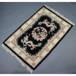 A black and white ground Chinese rug decorated dragons 177cm x 122cm