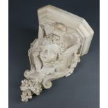 A 19th/20th Century plaster wall bracket in the form of a cherubs head with grape decoration 37cm