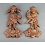 A pair of Chinese carved and pierced hardwood plaques depicting figures 23cm x 12cm