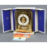 A Jaeger Lecoultre gilt metal cased Atmos clock - Atmos Classic V, 22cm h x 18cm w x 13.5cm d,