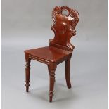 A Victorian carved mahogany hall chair with solid seat on turned supports 84cm h x 39cm w x 36cm