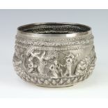 An Indian white metal repousse bowl decorated with a band of figures in a townscape 334 grams,