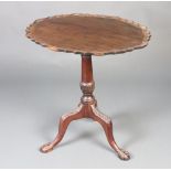 A 19th Century oval Chippendale style snap top wine table with pie crust edge, raised on a turned