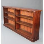 A Victorian mahogany bookcase fitted adjustable shelves, raised on a platform base 99cm h x 206cm