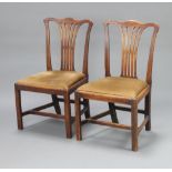 A pair of 19th Century Hepplewhite style mahogany slat back dining chairs with upholstered drop in