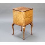 A 1930's Queen Anne style walnut bow front bedside cabinet fitted a cupboard, raised on cabriole